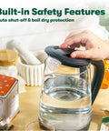 Person using 1.7 Liter Glass Electric Kettle That Boils Seven Cups In Just Six To Seven Minutes With Soft Blue LED Lights, Black Finish.