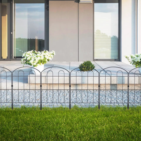 28 Pack Decorative Garden Fence Panels Outdoor Yard Friendly 24 Inch High 13 Inch Wide 30 Feet Long Coated Metal Rust Proof Wrought Iron Wire Border Folding Patio Fences For Flower Beds Animal Barrier Landscape Decor Easy Setup installed in front of a modern patio with potted plants and greenery