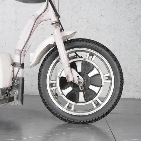 Close-up of front wheel showing the 16-inch bike tire with inner tube on a motorcycle, part of the Sixteen Inch Bike Tire With Inner Tube Set 16X2.125 For Electric Bicycles Motorcycles And Most Kids Bikes Heavy Duty Tubes Ride Ready With Wide Compatibility Including RoyalBaby Joystar Dynacraf.