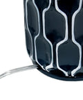 Close-up of handpainted white pattern on blue ceramic base of Blue Ceramic Table Lamp With Handpainted White Pattern, White Fabric Shade.