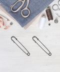 Vintage Heavy Duty Safety Pins For Sweaters And Cardigans Retro Iron Metal Decorative Brooch Clips on a crafting table.