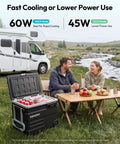 Smart 12V Car Fridge 59 Quarts With App Control And LCD Panel sitting outdoors with food and drinks by a stream.