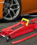 Heavy Duty Hydraulic Low Profile Floor Jack With Quick Lift Pump, 2.5 Ton Capacity, Trolley Style For Sedans, Durable Steel Construction, Single Piston Lift, Lifts From 3.33 Inches To 15 Inches, Red next to car tire