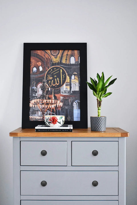 Dresser with 40 Pack Matte Black Cabinet Knobs, framed art, and plant on top, showcasing euro style knobs in modern room decor.
