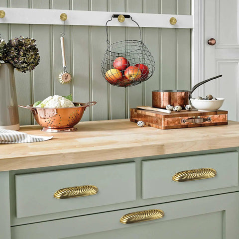 Top Shelf Modern Cabinet Pulls With 5 Inch Hole Centers And Brushed Gold Zinc Alloy Handles For Kitchen Drawers and Furniture Doors Six Pack displayed on a green cabinet.