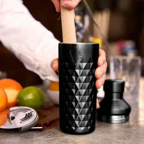 Person using Paragon Vacuum Insulated Cocktail Shaker With Built In Strainer in black, 23 oz double-walled stainless steel for cold drinks.