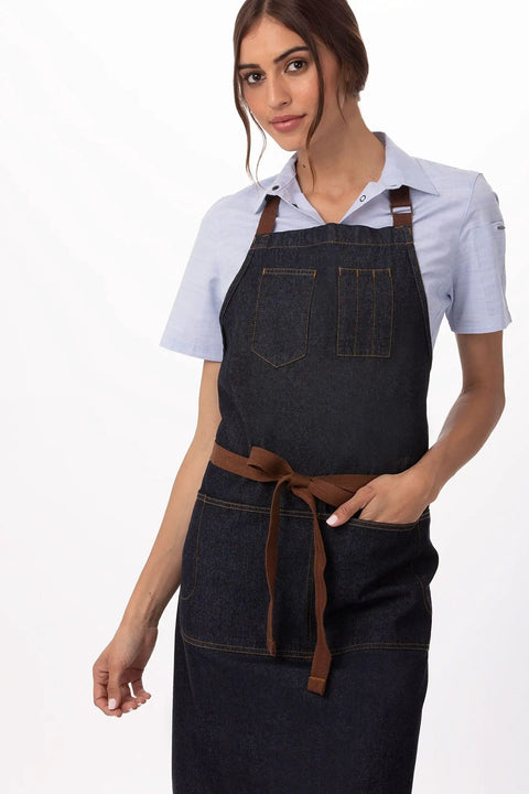 Woman wearing Unisex Memphis Bib Apron In Indigo Blue With Adjustable Neck Buckle And Waist Ties Durable Kitchen Waitstaff Apron