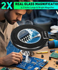 Man using Pro Grade 12X 30X Magnifying Glass With Light And Clamp, desk lamp with swing arm, soldering electronics