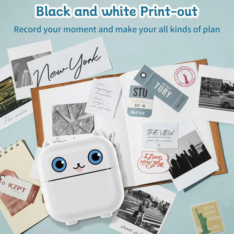 Pocket Sized Portable Bluetooth Mini Sticker Maker With Slick Inkless Thermal Tech And One Roll Of Glossy Paper For Snappy Journaling on a flat lay with various printouts.