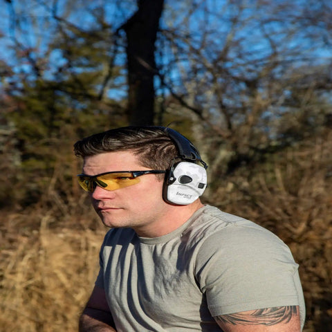 Man wearing Impact Sport Electronic Shooting Earmuff with Sound Amplification in Multicam Alpine outdoors.