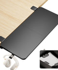 Heavy Duty Desk Extender Tray With Secure Laptop Holder And Generous Extra Surface Solid Keyboard Shelf That Seriously Levels Up Your Home Office Flex In Sleek Black, shown attached to a desk with headphones.