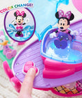 Minnie Mouse Bowdazzling Yacht Lights And Sounds Playset with color change feature, showing Minnie in a heart-shaped seat on pink yacht.