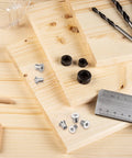 Pro Grade Dowel And Tenon Center Pins Set Features Twenty Four Pieces Across Six Exact Sizes on wooden boards with tools.