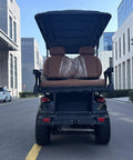 Hella Comfy 6 Seater Electric Golf Cart With Roof LED Light Bar showing plush diamond stitched seats from rear view on street.
