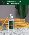 Bottle of Food Grade Mineral Oil For Bamboo And Wooden Cutting Boards And Kitchen Utensils on marble counter