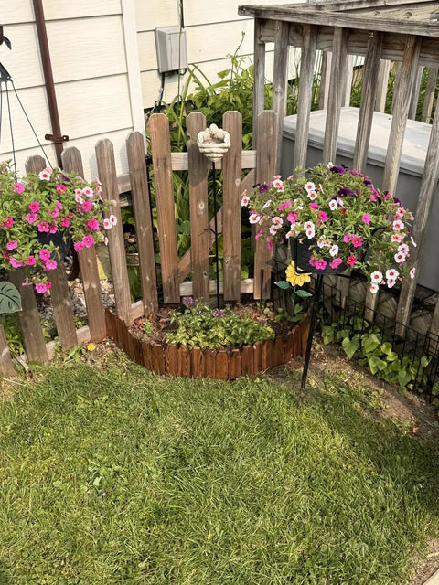 Garden Edging Kit With Rustic Picket Panels For Flower Beds And Landscape Borders Charred Wood Construction For Moisture And Rot Resistance 5.9 Inch High By 47 Inch Long 1 Pack installed in garden with flowers