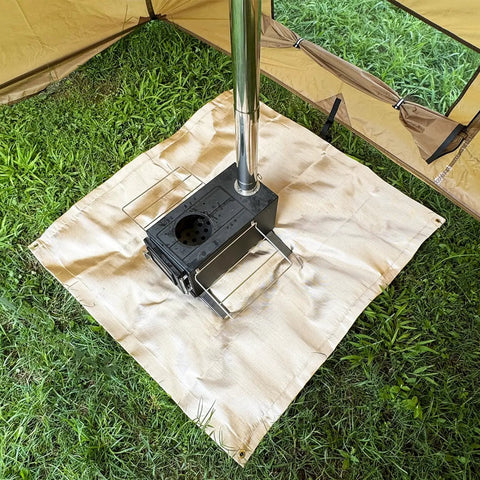Tent setting with 40 Inch Fire Pit Mat For Deck And Grill, Fiberglass Insulated Under Stove Pad With 940F Safety, protecting grass.