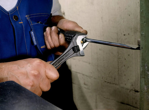 Person using Alligator Adjustable Wrench, 8 Inch, Slim Head With Tapered Jaws For Easy Reach And Extra Turning Power on a fastener