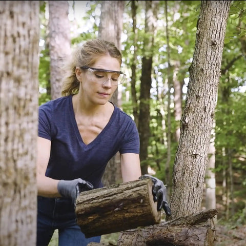 Top Shelf Anti Fog Safety Glasses Over Eyeglasses Clear Impact Resistant Polycarbonate Lenses worn by woman outdoors lifting logs.