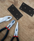 Heavy Duty Stainless Steel Mending Plates, Flat Metal Brackets For Quick Cabinet Fixing And Wood Repair, Zero Hassle Install With Included Screws, Solid As A Rock Furniture Reinforcement Kit Pack Of Ten with pliers on wooden surface.