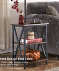 Oxford design end table in living room with three-tier wood storage, decorative items, and nearby sofa.