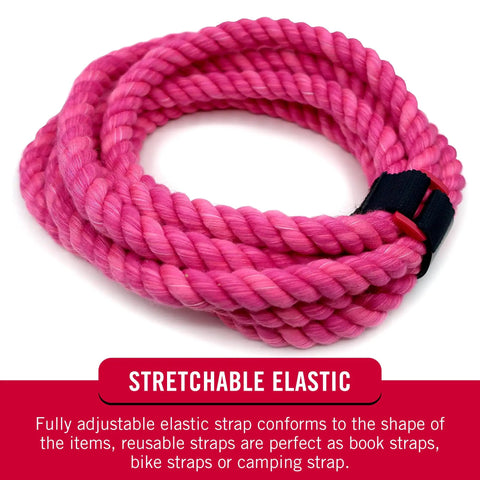 Pink elastic cinch strap coiled with black buckle, designed for securing cables and gear, showcasing its stretchability.
