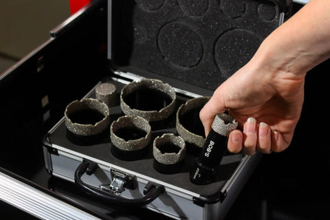 Person holding 25mm Diamond Hole Saw Drill Bit from 7-piece set in soft carry case for ceramic tile, glass, marble cutting