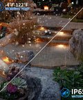 Outdoor pathway with 8 Pack 5W 12 Inch LED Hardscape Paver Lighting Kit in snow and rain, showcasing warm white 2700K lights on stone steps.