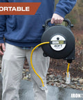 Man holding Heavy Duty Retractable Extension Cord Reel 40 Feet With 3 Outlets 12 Gauge SJTW 3 Prong Lighted Plug