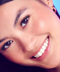 Close-up of a woman smiling with 10mm-12mm natural volume wisps from Complete DIY Eyelash Extensions Starter Kit for an at-home lash upgrade.