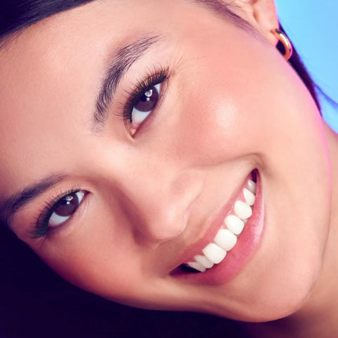Close-up of a woman smiling with 10mm-12mm natural volume wisps from Complete DIY Eyelash Extensions Starter Kit for an at-home lash upgrade.