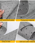 Heavy Duty Oil Absorbent Pads 100 Pack 13 X 10 Inch Meltblown Polypropylene close-up showing thickness and texture of pads.