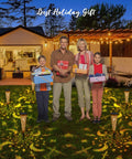 Family with gifts in backyard lit by Moon Star Solar Garden Stake Lights Outdoor Waterproof Copper Finish For Patio Pathway.