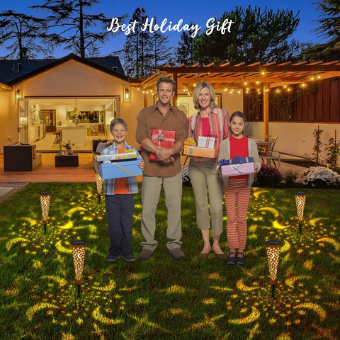 Family with gifts in backyard lit by Moon Star Solar Garden Stake Lights Outdoor Waterproof Copper Finish For Patio Pathway.