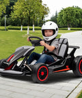 Child riding 24V Electric Go Kart For Kids 6 To 12 With Dual 200W Motors, 8.1 MPH Speed, Drift And 360 Spin, in park