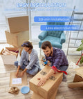 Couple sitting among moving boxes, assembling a 52 Inch Modern Ceiling Fan With Lights And Remote Control, Quiet DC Reversible Motor, Noiseless Performance, 3CCT LED Lighting, The Perfect Upgrade For Your Cozy Pad Bedroom Or Living Room Indoors Or Outdoors. Image emphasizes easy installation.