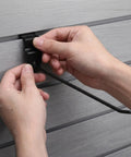Hands installing 20 Pieces Slat Wall Hooks For Retail Store Display And Hardware Shelf Racks Black Iron Hooks With 4mm Rod Thickness Burr Free Finish