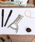 Heavy Duty One Hole Punch With Deep Throat Reach 2 Inch Long 1/8 Inch Hole Size on desk with notebook and pens