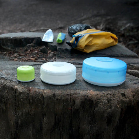GoTubb Mini Storage Containers For Snacks And Grab And Go Travel Gear With One Hand Snap Lid, Small 3 Pack on tree stump