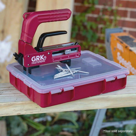GRK Fasteners tool with silver screws resting on a red storage box, ideal for handling Marine Grade Stainless Steel 316 Hidden Deck Screws Trim Head 2 3/8 Inch 200 Piece Pack Hella Tough Rust Resistant Fasteners For Wet Outdoor Wood Projects And Top Shelf Deck Upgrade Jobs.