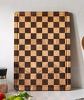 Real Deal Acacia Wood Checkered Cutting Board With Deep Juice Grooves And Solid Handles Large 17 Inch Butcher Block on kitchen counter.