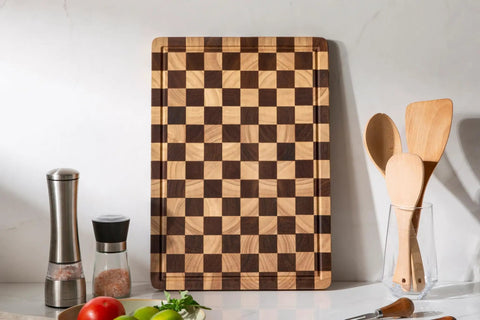 Real Deal Acacia Wood Checkered Cutting Board With Deep Juice Grooves And Solid Handles Large 17 Inch Butcher Block on kitchen counter.