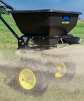 Spyker All Season Spreader Kit Ergo Pro 50 Pound Broadcast Spreader With 25 Pound Bag Spreader spreading on lawn