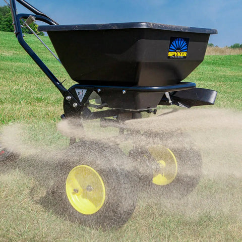 Spyker All Season Spreader Kit Ergo Pro 50 Pound Broadcast Spreader With 25 Pound Bag Spreader spreading on lawn