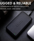 Beast 2TB External NVMe SSD With Thunderbolt 3 Ultra Fast 2800 MBs Read 2600 MBs Write For 4K 8K Editing VR And Big Media Backups Fanless Rugged Aluminum Enclosure Meets MIL STD 810F black SSD on desk