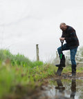 Man using Short-Handle Digging Shovel With Heavy Duty Carbon Steel Build, Ergonomic No-Slip H-Grip in muddy outdoor site