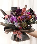 Bouquet wrapped with Black Flower Wrapping Paper with Gold Edges, showcasing vibrant flowers, 58x58 cm, for gift wrapping.