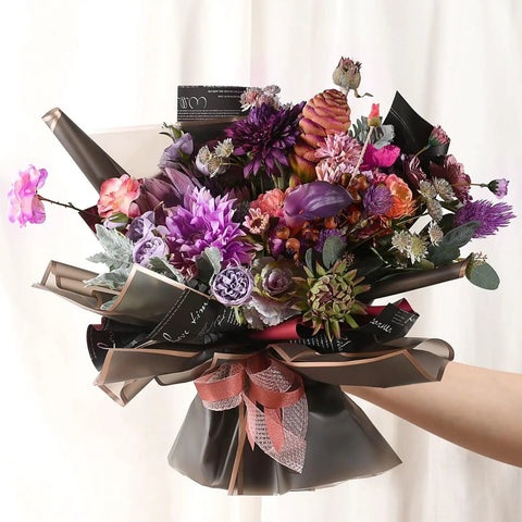 Bouquet wrapped with Black Flower Wrapping Paper with Gold Edges, showcasing vibrant flowers, 58x58 cm, for gift wrapping.