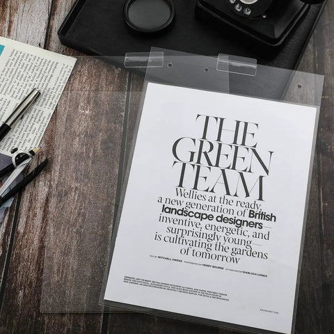 Three Pack 8.5x11 Clear Slat Wall Sign Holders For Menus And Flyers displaying a magazine page on a wooden desk