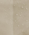 Close-up of water-repellent fabric on round patio table and chair set cover showing all-weather protection.